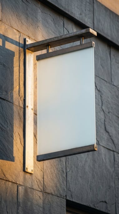 Metal bracket blade sign on a dark slate building exterior