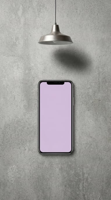 Smartphone lying face up on a concrete desk, blank solid pale lilac screen with no content