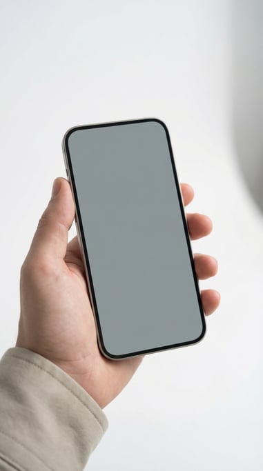 Hand holding a smartphone against a clean white studio background