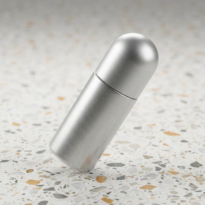 Roll-on bottle in brushed aluminum, single at dramatic angle