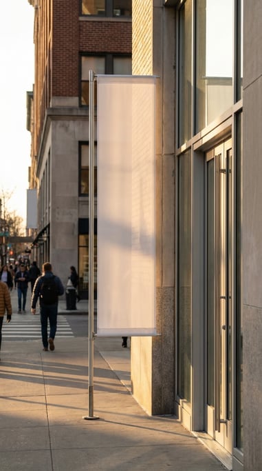 Tall vertical banner flag on a pole beside a glass entrance door