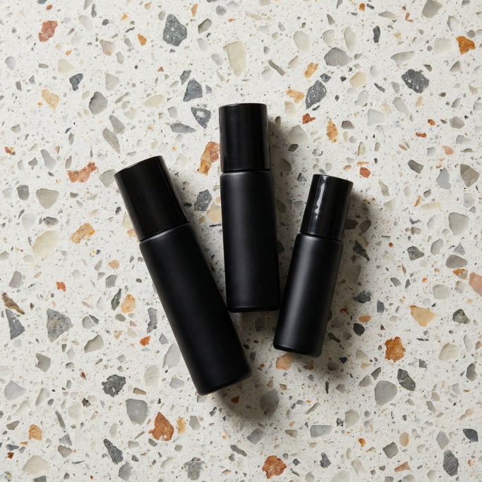 Roll-on bottle in matte black, cluster of three different sizes