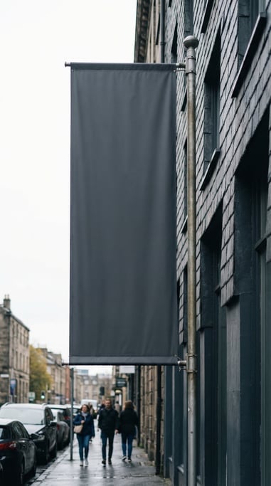 Tall vertical banner flag on a pole on a dark slate building exterior