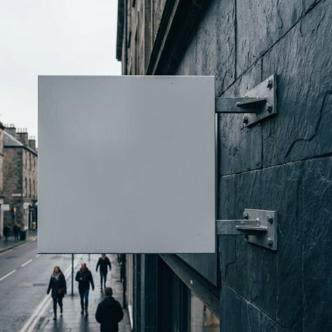 Square wall-mounted blade sign on a dark slate building exterior