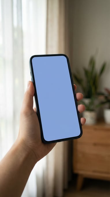 Hand holding a large-screen smartphone near a window with soft natural light