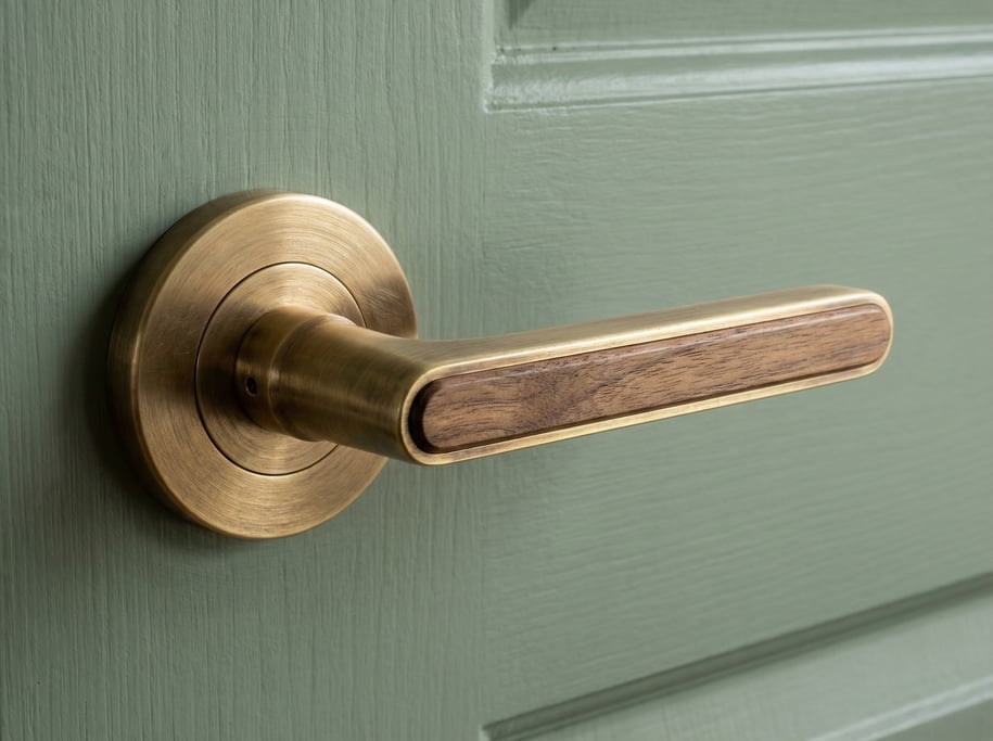 Detail of a walnut and brass interior door handle set