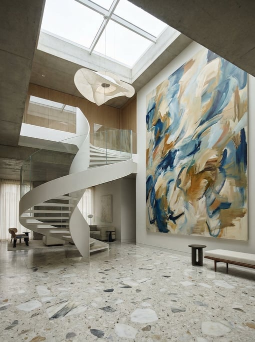 Dramatic double-height foyer with a floating helical staircase in white-painted steel