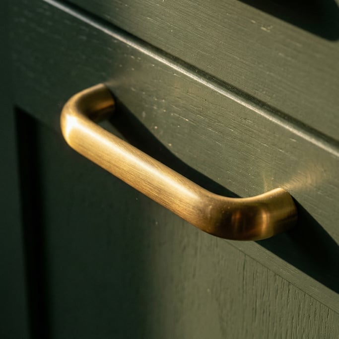 Close-up of a modern cabinet pull in brushed brass
