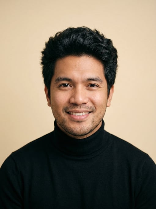Professional studio headshot of a 30-year-old Filipino man with thick coarse black hair with natural