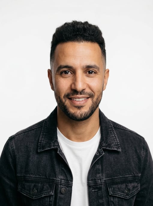Professional studio headshot of a 36-year-old North African man with a mid fade with textured top