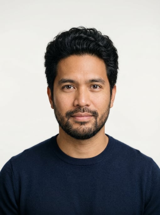Professional studio headshot of a 36-year-old Filipino man with thick coarse black hair with natural