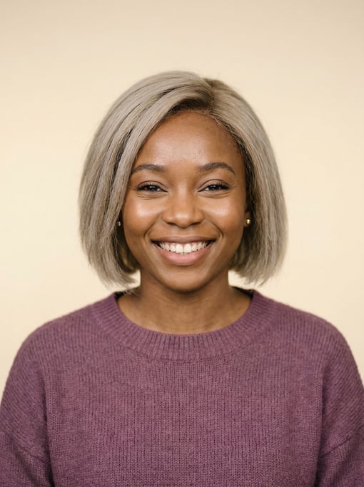 Professional studio headshot of a 26-year-old Black African woman with a chin-length bob in ash blon