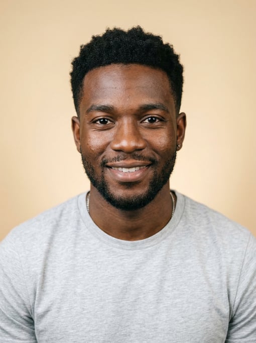Professional studio headshot of a 25-year-old Jamaican man with short textured black hair