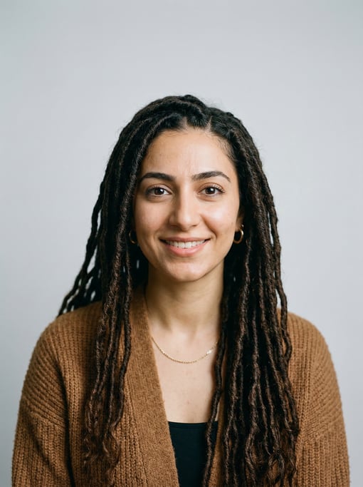 Professional studio headshot of a 26-year-old Persian woman with long goddess locs in dark brown