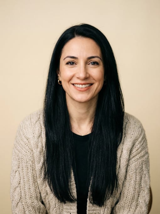 Professional studio headshot of a 37-year-old White Mediterranean woman with long straight black hai