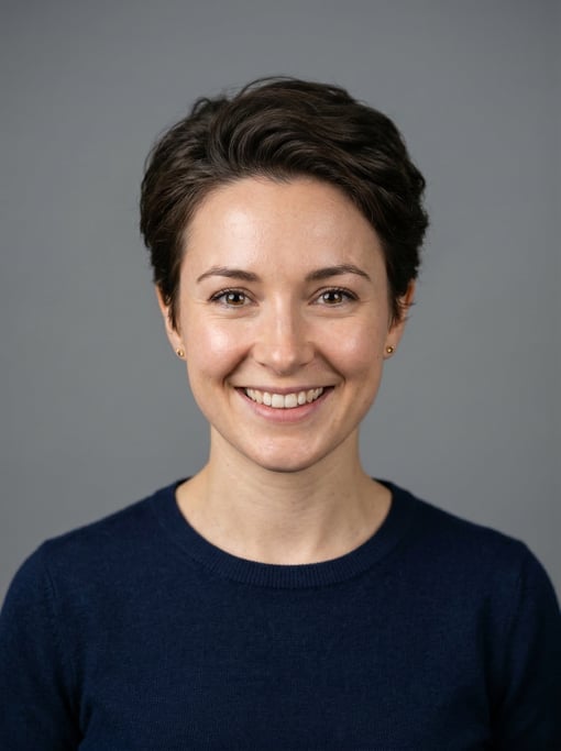 Professional studio headshot of a 28-year-old White British woman with a tapered natural cut in dark
