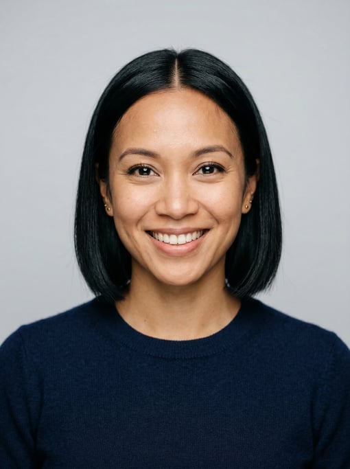 Professional studio headshot of a 33-year-old mixed-race woman with a blunt bob in jet black with a