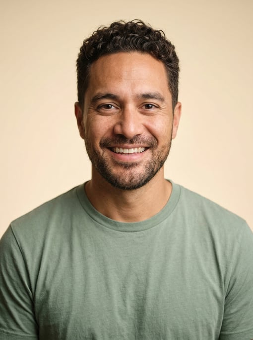 Professional studio headshot of a 39-year-old Pacific Islander man with short curly dark brown hair