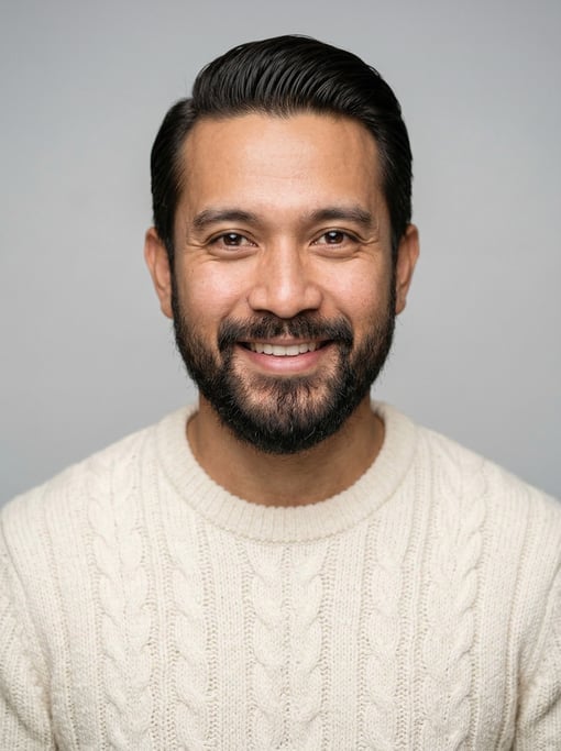 Professional studio headshot of a 34-year-old Indonesian man with a slicked-back style in dark brown