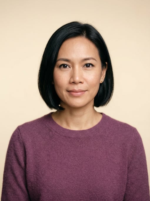 Professional studio headshot of a 39-year-old Thai woman with a chin-length bob in jet black