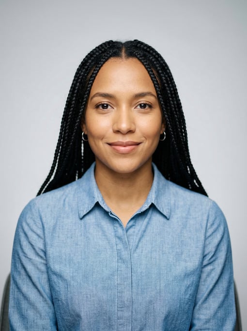 Professional studio headshot of a 26-year-old Colombian woman with long box braids in black