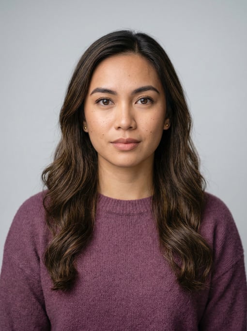 Professional studio headshot of a 24-year-old Filipino woman with long wavy dark brown hair
