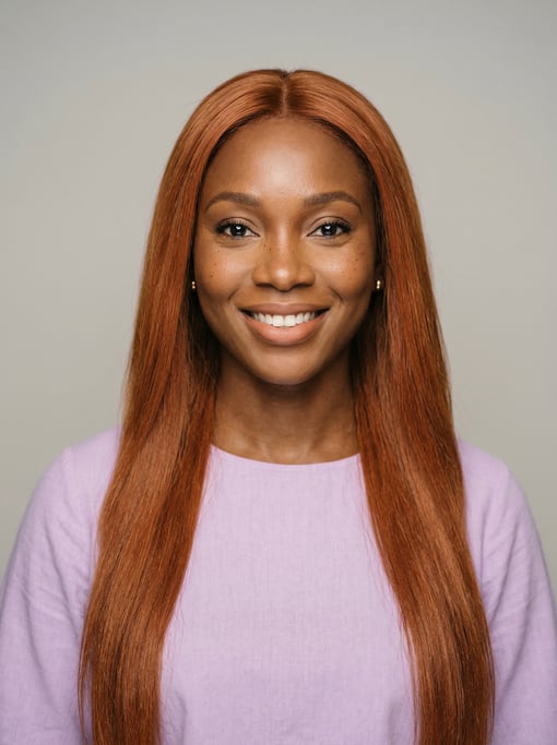 Professional studio headshot of a 31-year-old Nigerian woman with long straight copper red hair