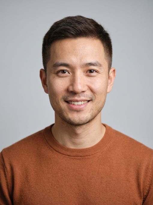 Professional studio headshot of a 33-year-old Chinese man with short cropped dark brown hair