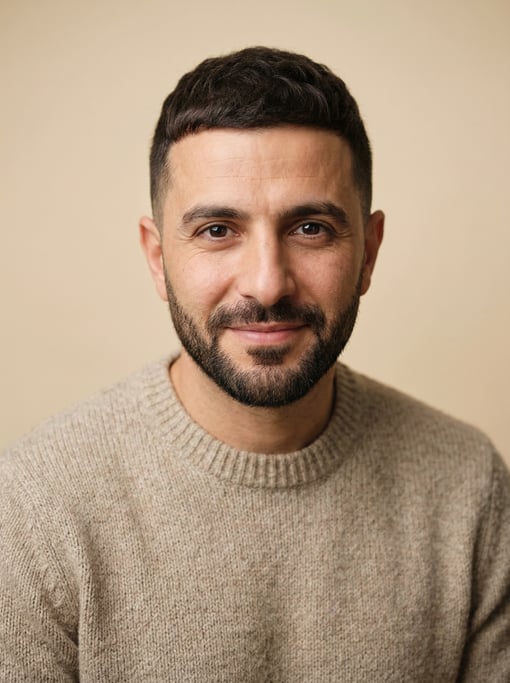 Professional studio headshot of a 39-year-old Lebanese man with a French crop in dark brown