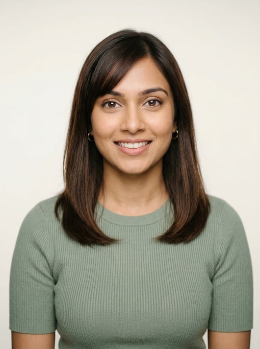 Professional studio headshot of a 25-year-old Sri Lankan woman with shoulder-length straight brown h