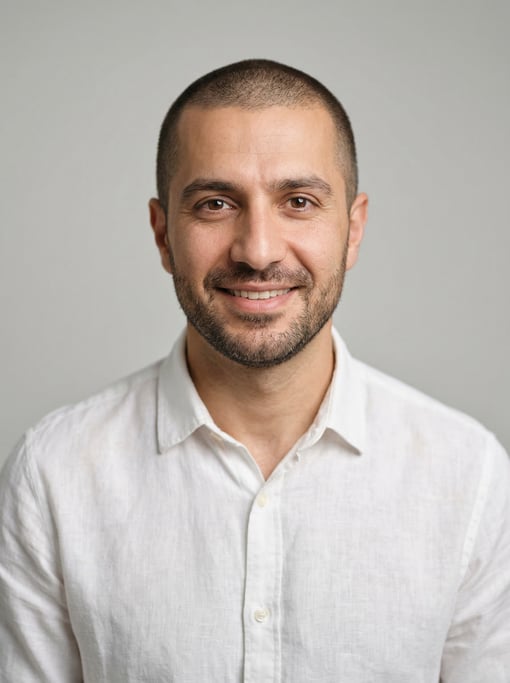 Professional studio headshot of a 37-year-old Persian man with a buzz cut in brown