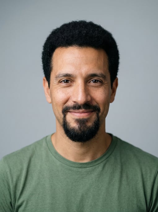 Professional studio headshot of a 37-year-old Argentinian man with a short natural afro in black