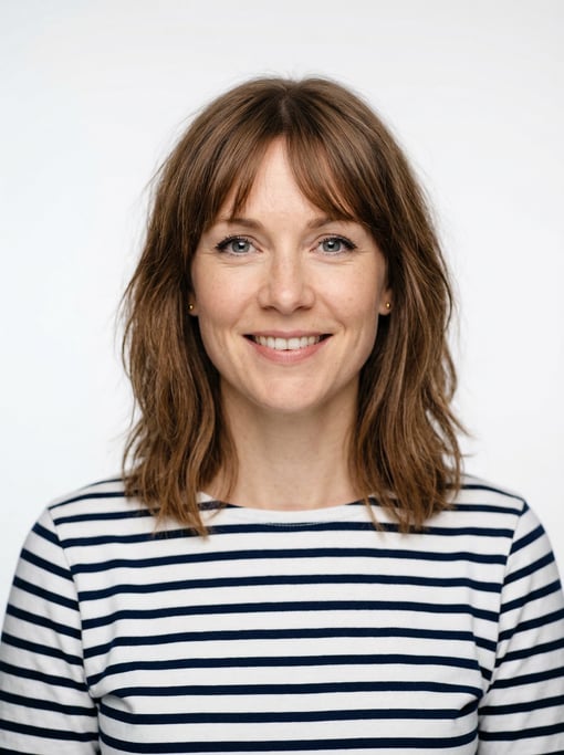 Professional studio headshot of a 33-year-old White Nordic woman with wispy bangs with a long bob in