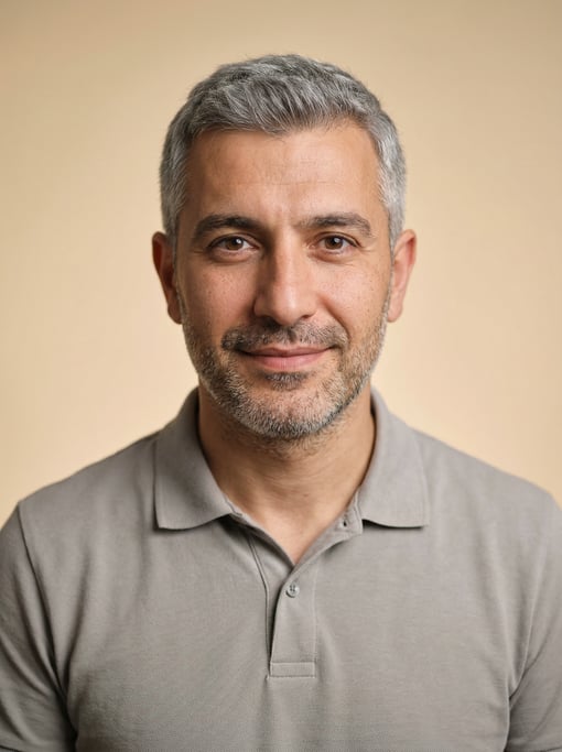 Professional studio headshot of a 35-year-old Turkish man with fully grey short cropped hair