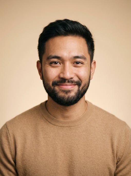 Professional studio headshot of a 25-year-old Southeast Asian man with short textured dark brown hai