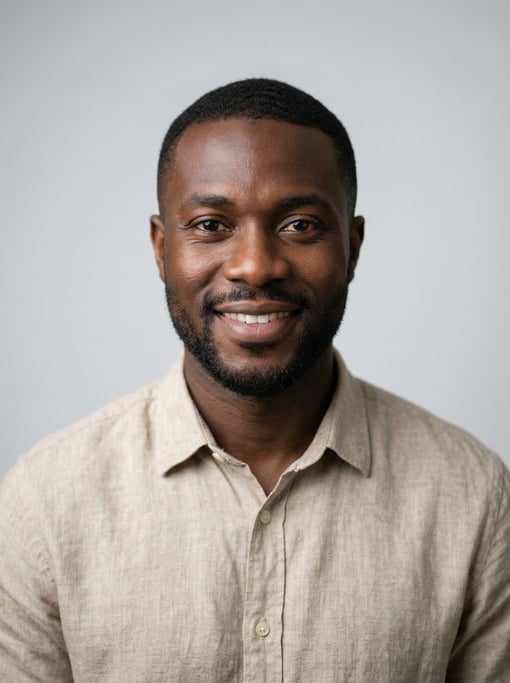 Professional studio headshot of a 31-year-old Ghanaian man with short cropped black hair