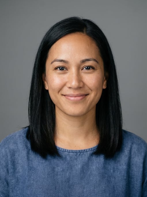 Professional studio headshot of a 32-year-old Hawaiian woman with shoulder-length straight black hai