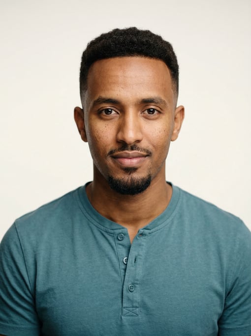 Professional studio headshot of a 24-year-old Ethiopian man with a taper fade in dark brown