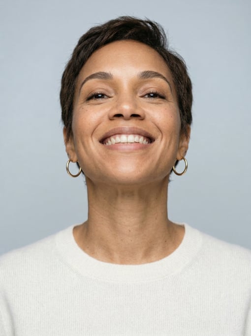 Professional studio headshot of a 36-year-old Jamaican woman with a short pixie cut in dark brown