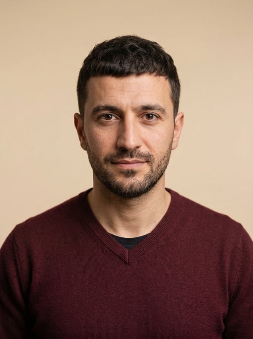 Professional studio headshot of a 35-year-old Turkish man with a dark brown textured crop