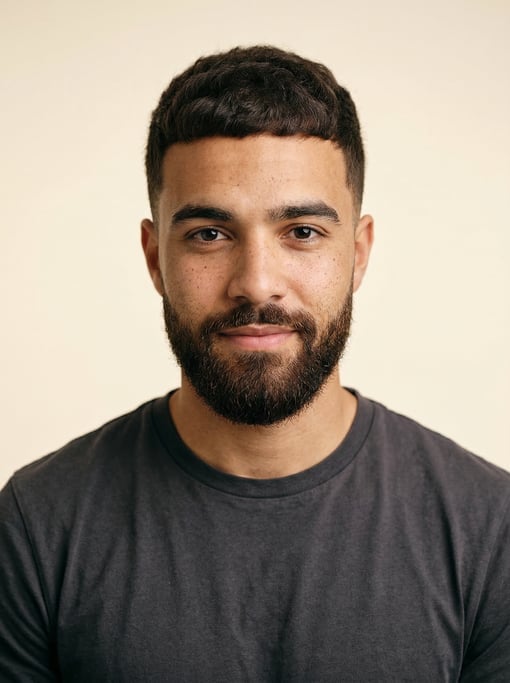 Professional studio headshot of a 24-year-old mixed-race man with a French crop in dark brown