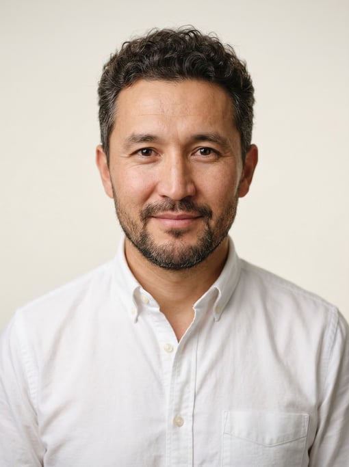 Professional studio headshot of a 40-year-old Central Asian man with short curly dark brown hair