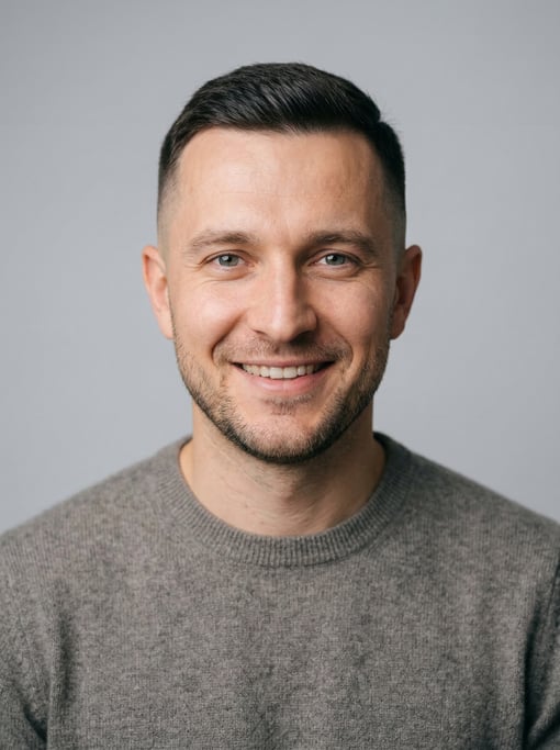 Professional studio headshot of a 35-year-old White Eastern European man with a short clean fade
