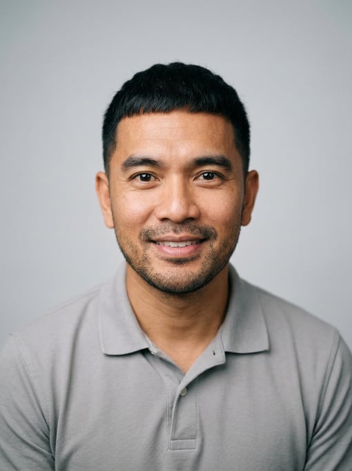 Professional studio headshot of a 40-year-old Southeast Asian man with a Caesar cut in black