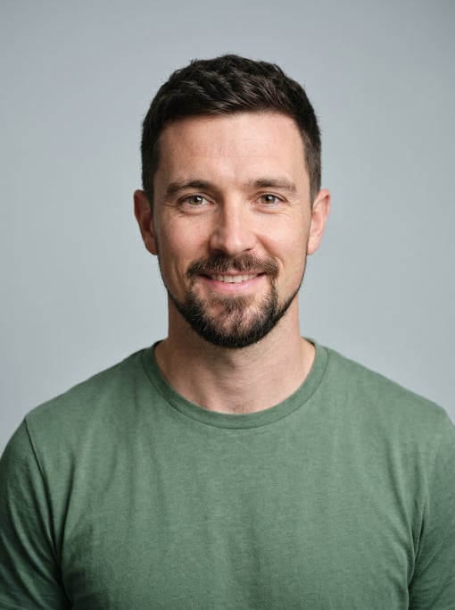 Professional studio headshot of a 33-year-old White European man with a dark brown textured crop