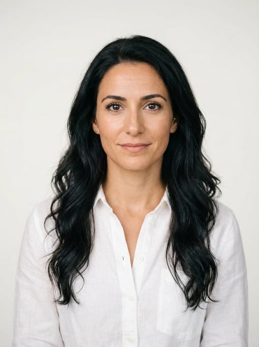 Professional studio headshot of a 32-year-old White Mediterranean woman with long wavy black hair