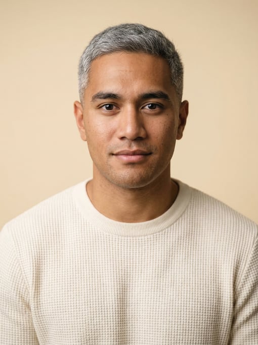Professional studio headshot of a 25-year-old Polynesian man with fully grey short cropped hair