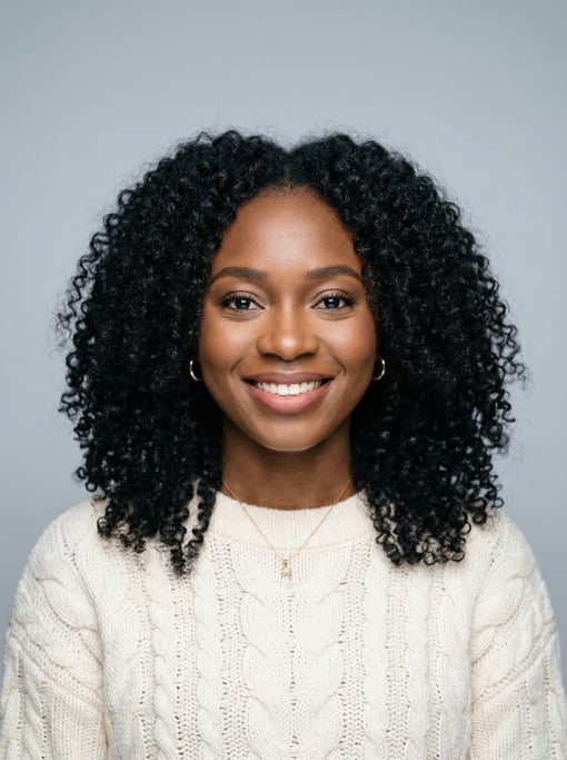 Professional studio headshot of a 25-year-old Nigerian woman with long tight curls in black