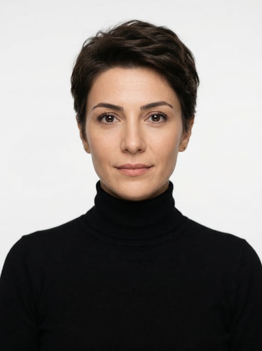 Professional studio headshot of a 34-year-old Turkish woman with a short pixie cut in dark brown