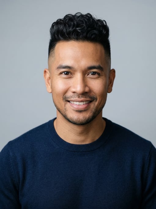 Professional studio headshot of a 36-year-old Thai man with a skin fade with longer curly top